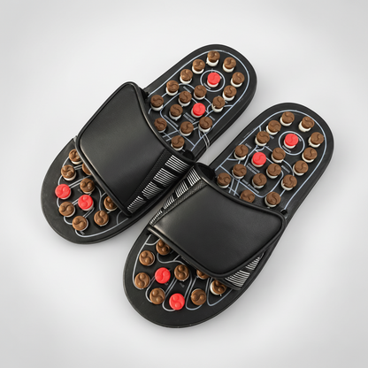 Adjustable acupressure slippers shown on a warm ivory studio background
