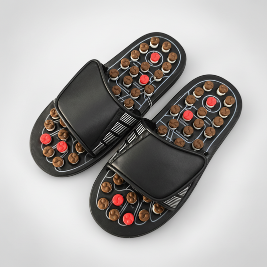 Adjustable acupressure slippers shown on a warm ivory studio background